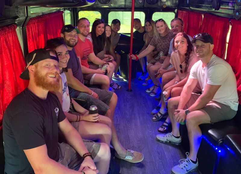 A group of people are sitting on the back of a bus.