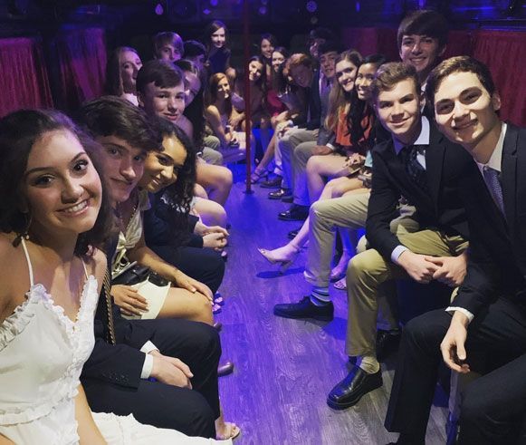 A group of people are posing for a picture in a dark room